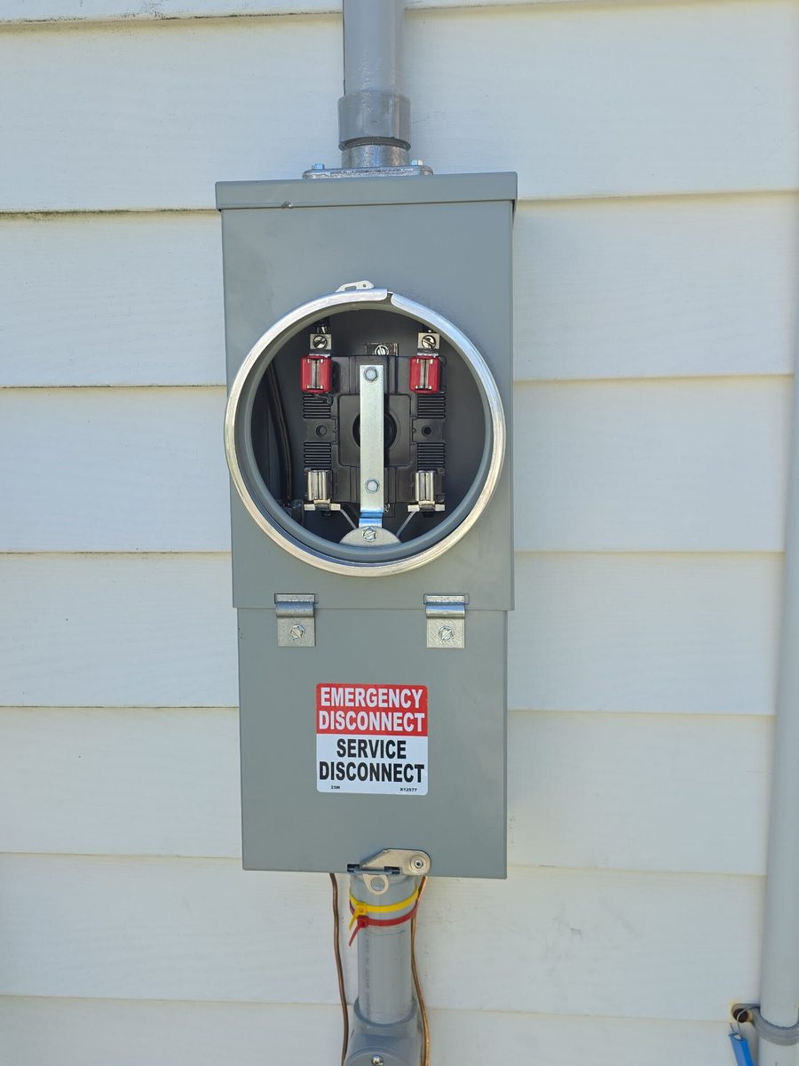 After: new gray meter base with an emergency service disconnect, labeled Emergency Disconnect / Service Disconnect